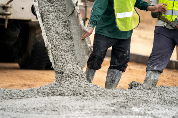 construction-worker-pouring-wet-concret-road-construction-site_33835-1155